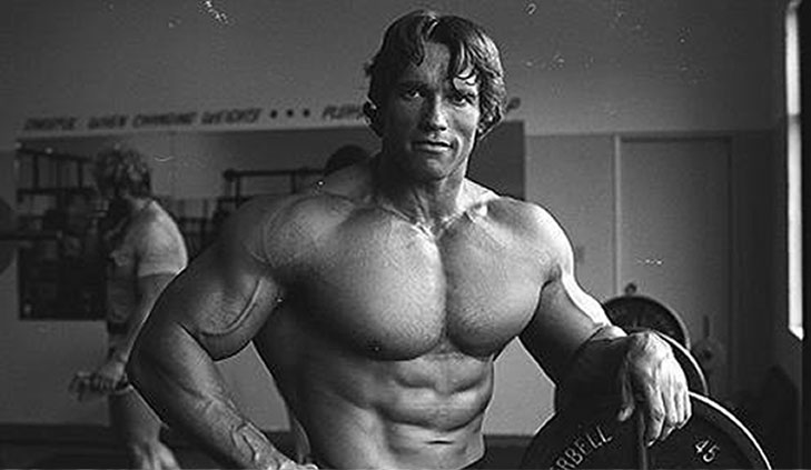 Arnold Schwarzenegger black and white photo topless in a gym working out and posing. The Important Cinema Club #86 Arnold Schwarzenegger Can't Stop Won't Stop